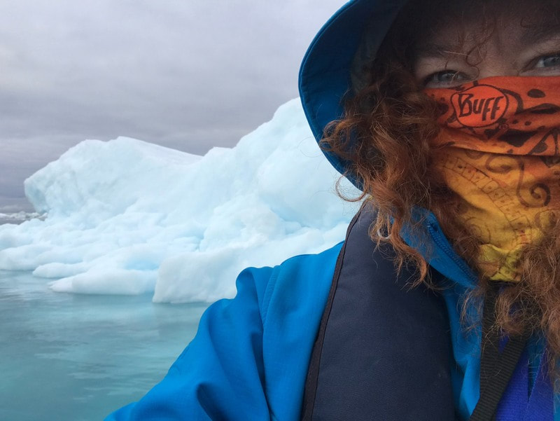 Jill Gleeson in front of an iceberg in the Arctic, off the coast of Greenland